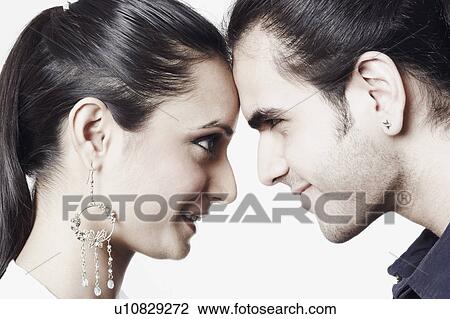 Stock Image - Close-up of a young couple looking at each other. Fotosearch