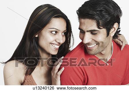 Stock Photograph - Close-up of a young couple looking at each other. Fotosearch
