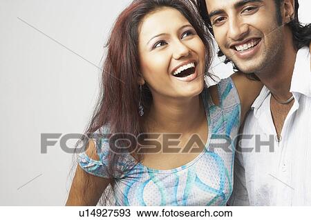 Close-up of a young couple smiling View Large Photo Image Stock Image - Close-up of a young couple smiling. Fotosearch