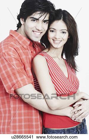 Stock Image - Close-up of a young couple smiling. Fotosearch