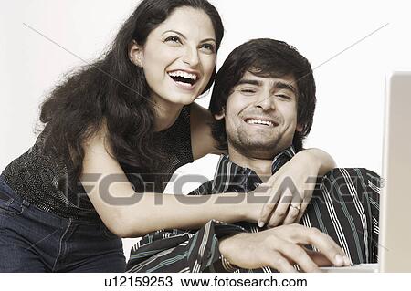 Low angle view of a young couple smiling View Large Photo Image Stock Image - Low angle view of a young couple smiling. Fotosearch