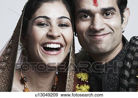 Portrait of a newlywed couple smiling View Large Photo Image Stock Photo - Portrait of a newlywed couple smiling. Fotosearch