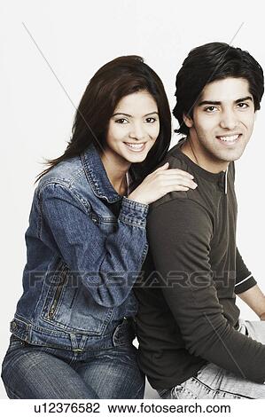 Stock Image - Portrait of a young couple smiling. Fotosearch