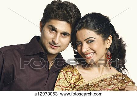 Stock Image - Portrait of a young couple smiling. Fotosearch
