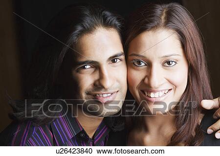 Stock Image - Portrait of a young couple smiling. Fotosearch