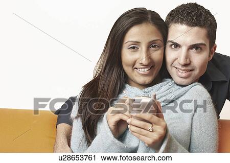 Portrait of a young couple smiling View Large Photo Image Stock Image - Portrait of a young couple smiling. Fotosearch