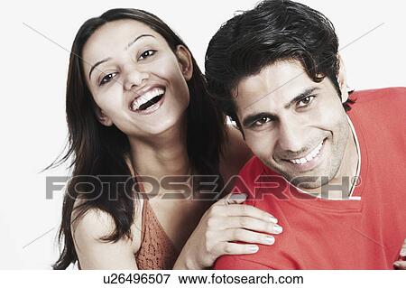 Stock Photo - Portrait of a young couple smiling. Fotosearch