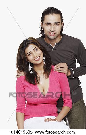 Stock Photography - Portrait of a young couple smiling. Fotosearch