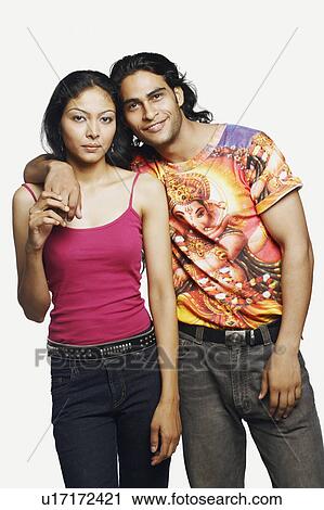 Portrait of a young man standing with his arm around a mid adult woman and smiling View Large Photo Image Stock Image - Portrait of a young man standing with his arm around a mid adult woman and smiling. Fotosearch