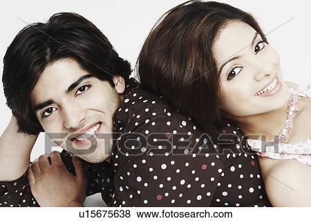 Stock Photo - Portrait of a young woman lying on a young man's back. Fotosearch