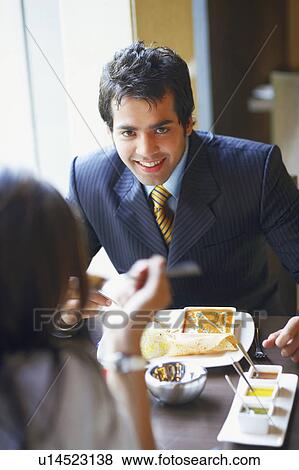 Close-up of a businessman and a businesswoman in a restaurant View Large Photo Image Stock Photo - Close-up of a businessman and a businesswoman in a restaurant. Fotosearch
