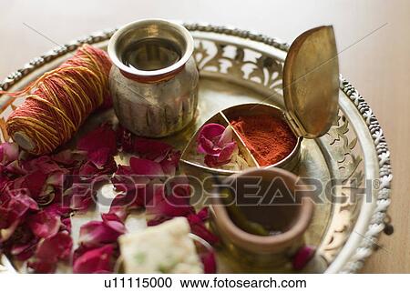 Stock Image - Close-up of traditional offerings in a plate. Fotosearch