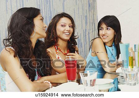 Three young women talking to each other View Large Photo Image Picture - Three young women talking to each other. Fotosearch