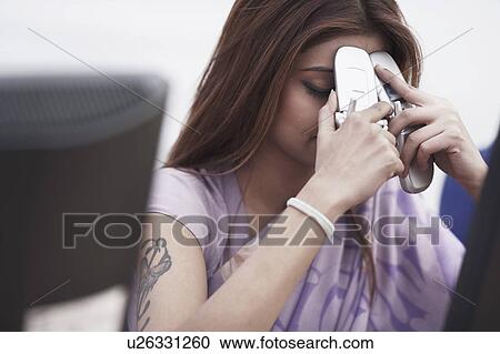 Close-up of a businesswoman holding two mobile phones View Large Photo Image Stock Image - Close-up of a businesswoman holding two mobile phones. Fotosearch