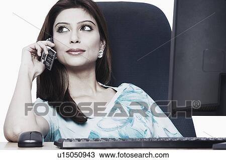Stock Image - Close-up of a businesswoman talking on a mobile phone. Fotosearch