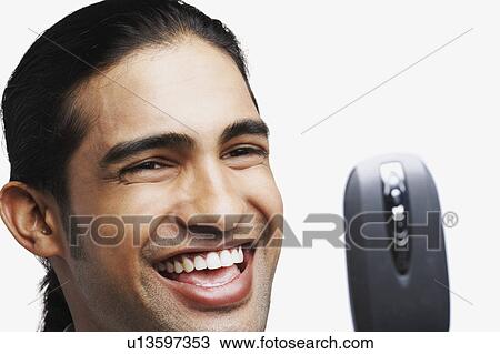 Stock Image - Close-up of a young man with a mobile phone. Fotosearch