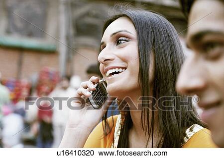 Stock Image - Close-up of a young woman talking on a mobile phone. Fotosearch