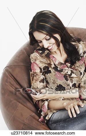 Close-up of a young woman using a mobile phone View Large Photo Image Picture - Close-up of a young woman using a mobile phone. Fotosearch