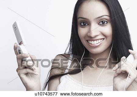 Stock Photo - Portrait of a teenage girl holding a mobile phone. Fotosearch