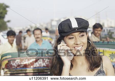 Stock Image - Young woman talking on a mobile phone. Fotosearch