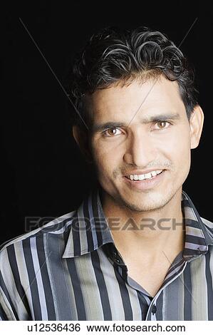 Portrait of a young man smiling View Large Photo Image Stock Photograph - Portrait of a young man smiling. Fotosearch