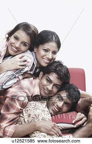 Close-up of two young men and two young women lying on top of each other smiling View Large Photo Image Stock Photography - Close-up of two young men and two young women lying on top of each other smiling. Fotosearch
