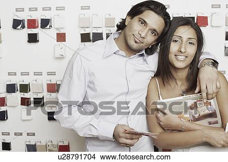 Portrait of a young couple standing at a fabric store View Large Photo Image Picture - Portrait of a young couple standing at a fabric store. Fotosearch