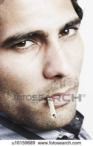 Portrait of a young man with a bidi in his mouth View Large Photo Image Stock Photo - Portrait of a young man with a bidi in his mouth. Fotosearch