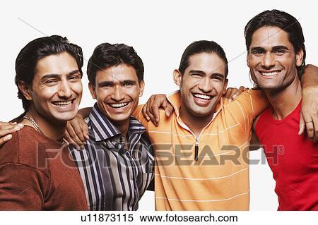 Stock Photography - Portrait of four young men standing side by side with their arms around each other. Fotosearch