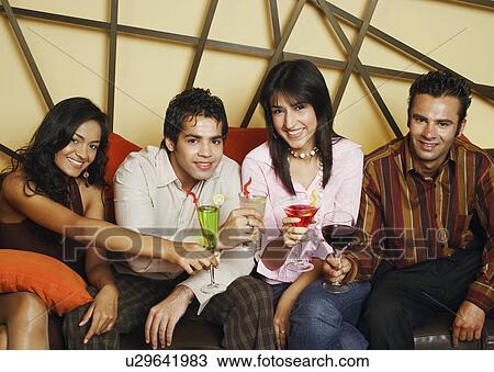Portrait of two young men and two young women making a toast View Large Photo Image Stock Image - Portrait of two young men and two young women making a toast. Fotosearch