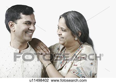 Close-up of a mature couple smiling View Large Photo Image Stock Image - Close-up of a mature couple smiling. Fotosearch
