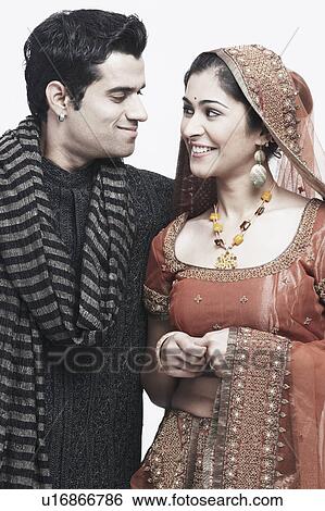 Close-up of a newlywed couple looking at each other View Large Photo Image Stock Photograph - Close-up of a newlywed couple looking at each other. Fotosearch