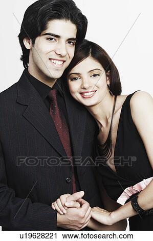 Stock Image - Portrait of a young couple holding hands. Fotosearch