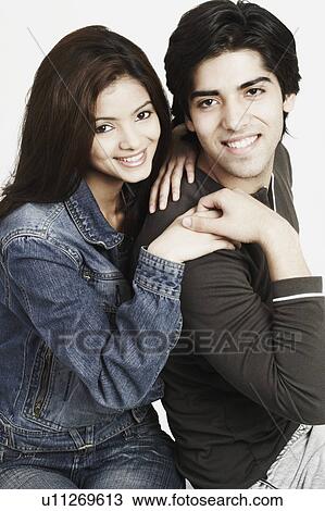 Portrait of a young couple smiling View Large Photo Image Stock Image - Portrait of a young couple smiling. Fotosearch