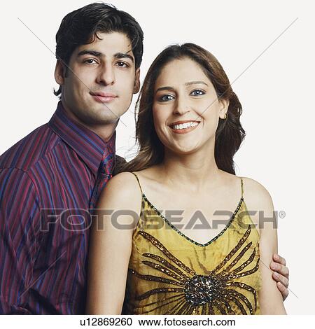 Stock Image - Portrait of a young couple smiling. Fotosearch