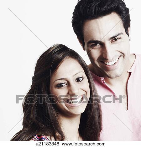 Stock Photo - Portrait of a young couple smiling. Fotosearch