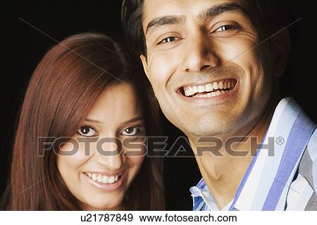 Stock Photo - Portrait of a young couple smiling. Fotosearch
