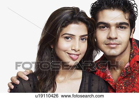 Portrait of a young couple smiling View Large Photo Image Stock Photograph - Portrait of a young couple smiling. Fotosearch