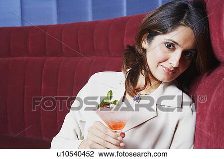 Portrait of a businesswoman holding a glass of martini View Large Photo Image Stock Image - Portrait of a businesswoman holding a glass of martini. Fotosearch