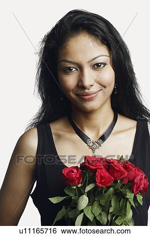 Stock Photograph - Portrait of a young woman holding a bunch of roses. Fotosearch