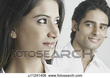 Stock Photograph - Young man looking at a young woman. Fotosearch