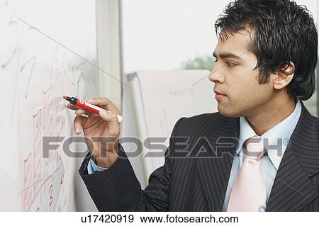 Stock Photo - Close-up of a businessman writing on a whiteboard. Fotosearch