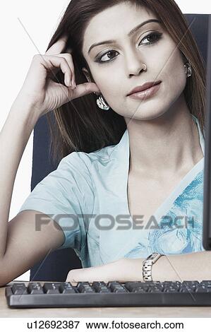 Close-up of a businesswoman with her hand on her head View Large Photo Image Stock Photo - Close-up of a businesswoman with her hand on her head. Fotosearch