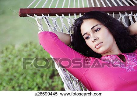 Close-up of a young woman lying in a hammock View Large Photo Image Stock Photography - Close-up of a young woman lying in a hammock. Fotosearch