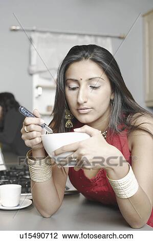 Close-up of a young woman holding a bowl View Large Photo Image Stock Image - Close-up of a young woman holding a bowl. Fotosearch