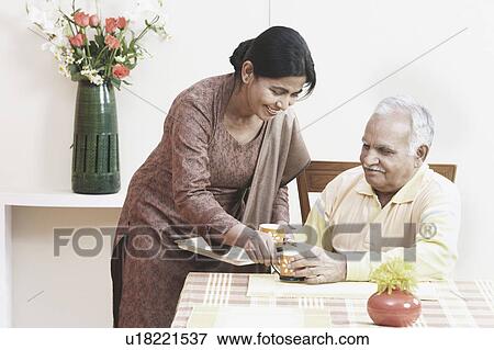 Mature woman serving tea to a mature man View Large Photo Image Stock Photo - Mature woman serving tea to a mature man. Fotosearch