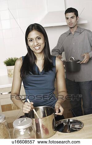 Portrait of a young woman mixing ingredient with a ladle View Large Photo Image Stock Photo - Portrait of a young woman mixing ingredient with a ladle. Fotosearch