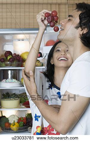 Young woman holding a bunch of plums near a young man's mouth View Large Photo Image Stock Image - Young woman holding a bunch of plums near a young man's mouth. Fotosearch