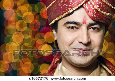 Stock Photograph - Portrait of a groom in a traditional wedding outfit. Fotosearch