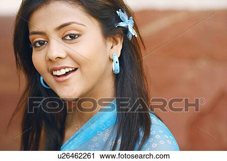 Portrait of a young woman smiling View Large Photo Image Stock Image - Portrait of a young woman smiling. Fotosearch